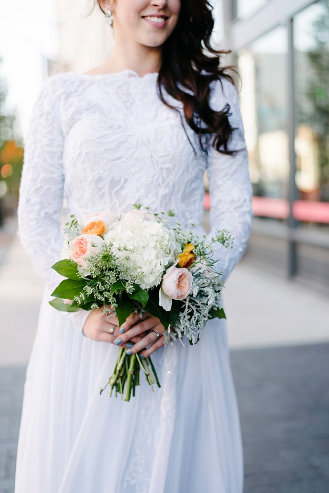 We're loving this bride's garden rose bouquet and vintage long sleeve dress!