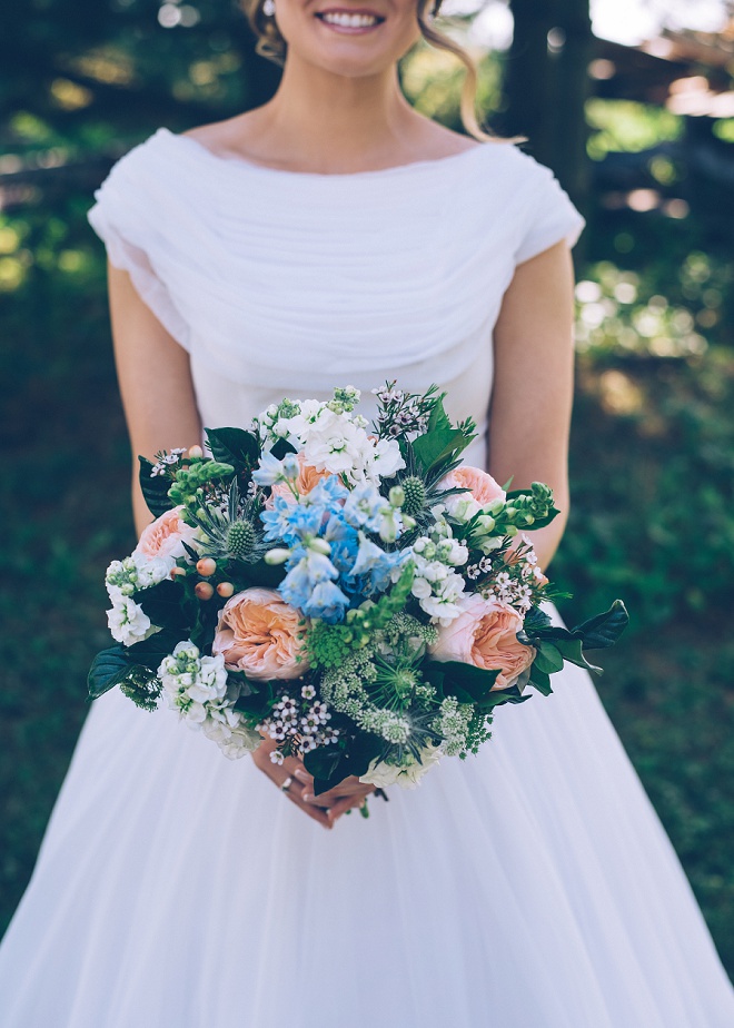 LOVING this gorgeous bouquet featuring a blue flower in memory of the Bride's mother.