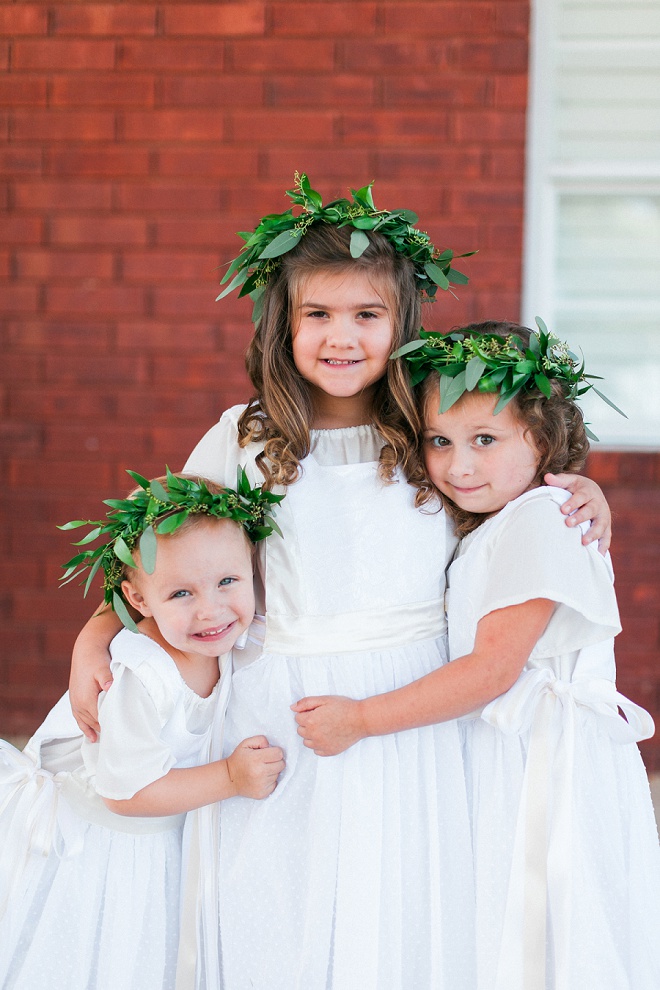 Dying over these darling flower girls in their green flower crowns and ribbon shoes!