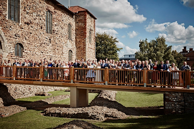 What a fun photo of the entire wedding at this UK castle wedding ceremony!