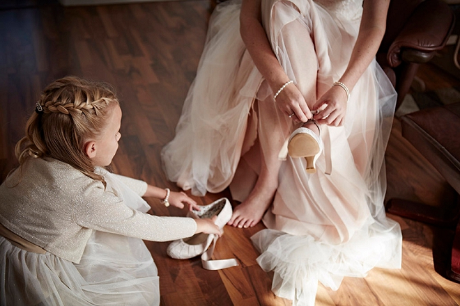 How darling is this Flower Girl helping the Bride get ready for the big day? So sweet!