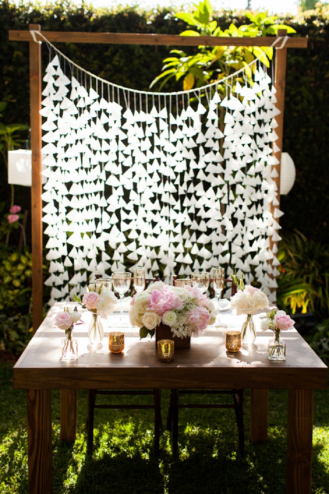 Swooning over this gorgeous sweetheart table and their gorgeous DIY backdrop!