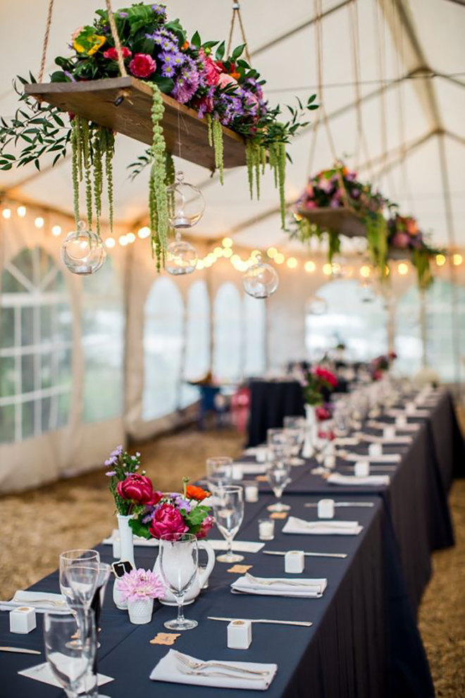 Hanging platforms with florals is a great way to dress up your wedding tent