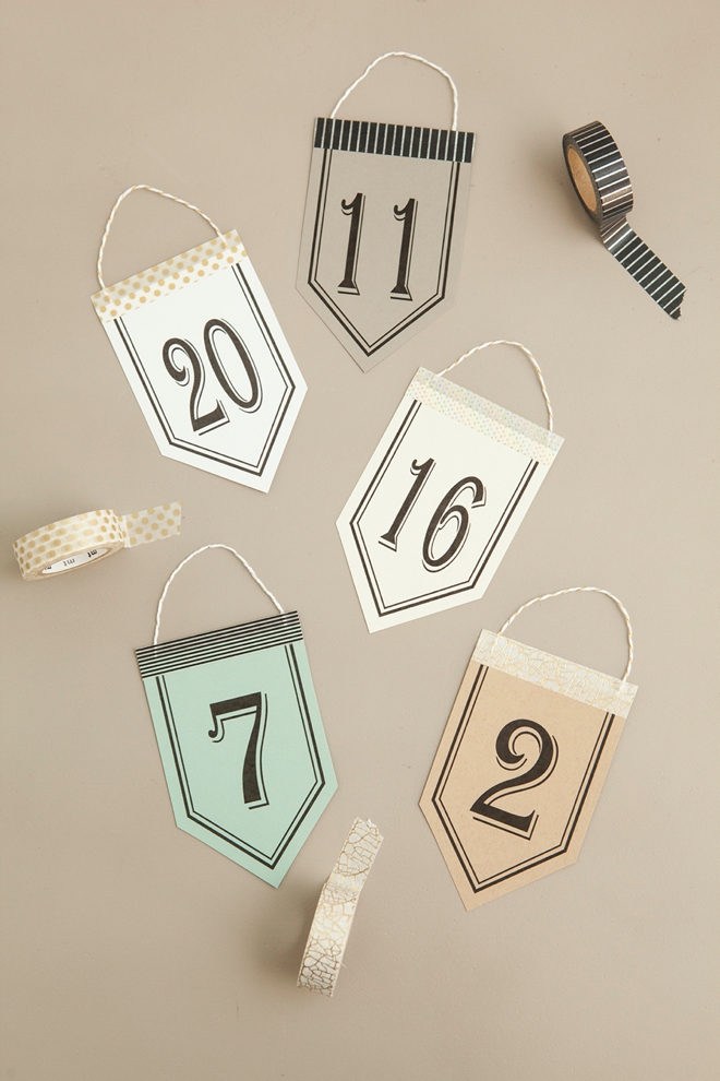 Check out these unique, DIY hanging table number stands with free printable numbers!