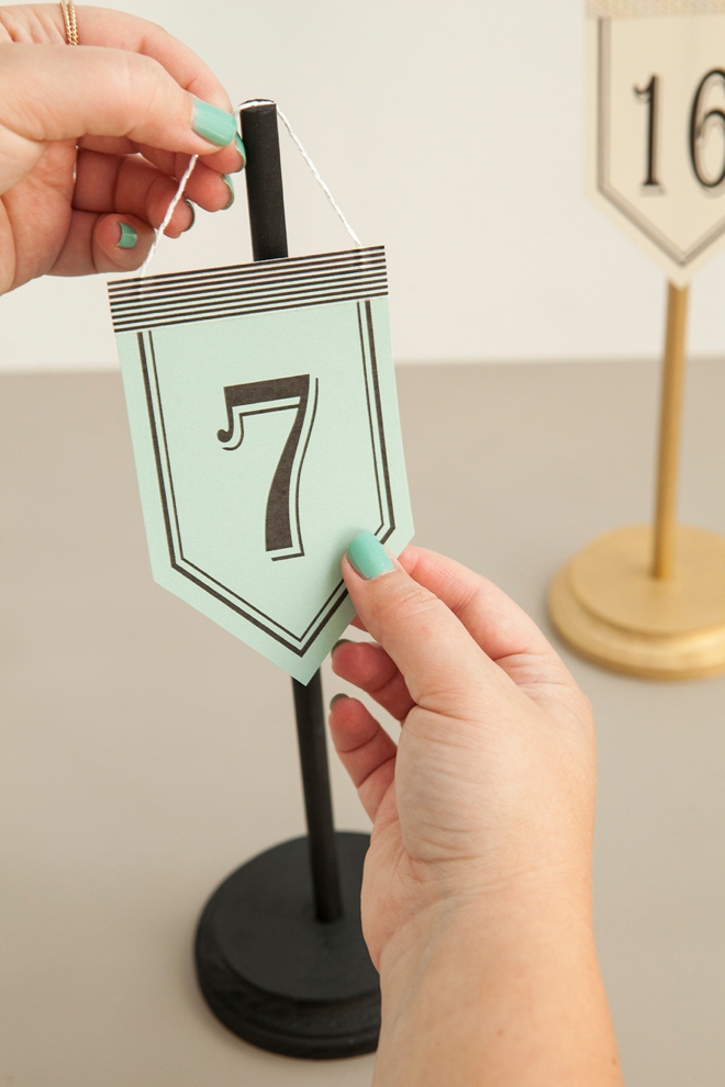 Check out these unique, DIY hanging table number stands with free printable numbers!