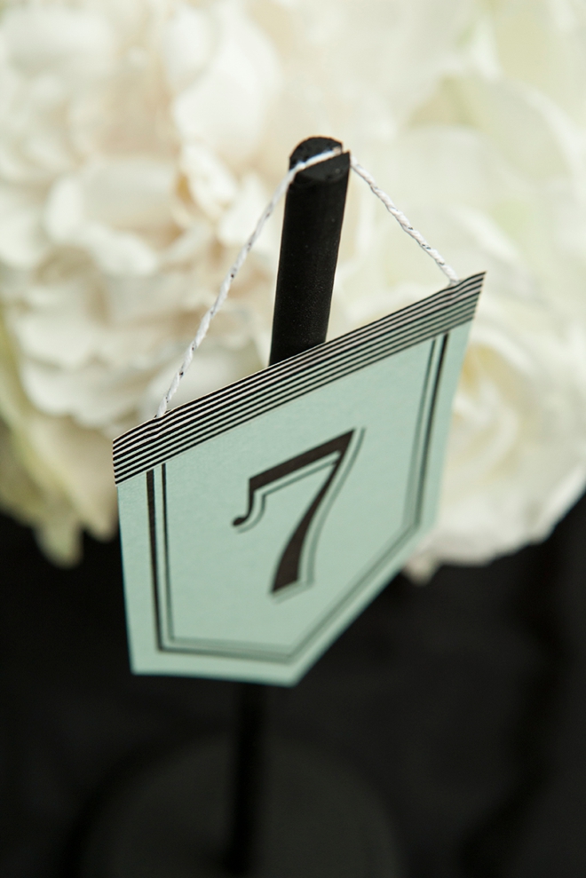 Check out these unique, DIY hanging table number stands with free printable numbers!