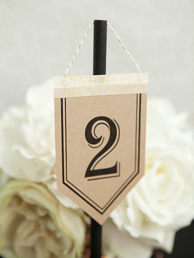 Check out these unique, DIY hanging table number stands with free printable numbers!