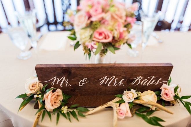 We're in love with this gorgeous hand lettered wooden Mr. and Mrs. sign for this couples sweetheart table!