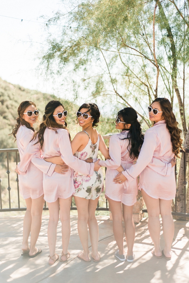 We're loving this super cute photo of the Bride getting ready with her Bridesmaids!