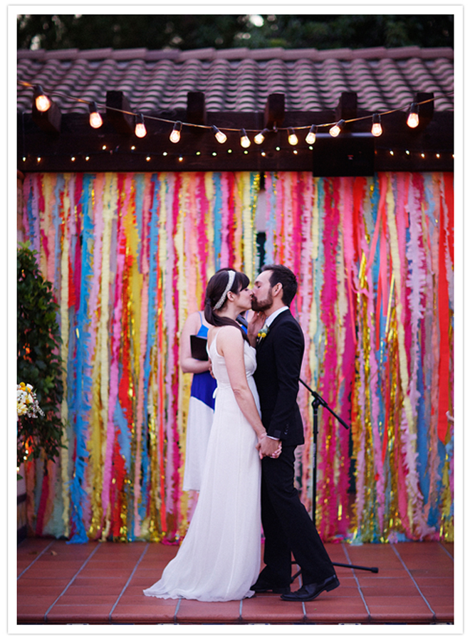 How stunning is this DIY bright and colorful streamer ceremony background?! Love!