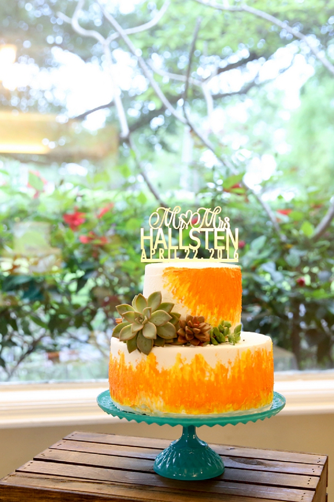Crushing on this couple's bright and gorgeous wedding cake and gold personalized cake topper!