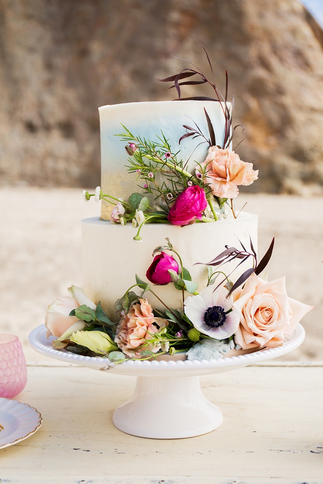 We're swooning hard over this stunning cake and vintage rental display!