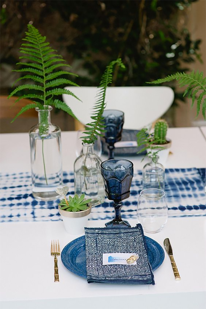 fern sprigs layered on pretty textiles make you not miss flowers at all.