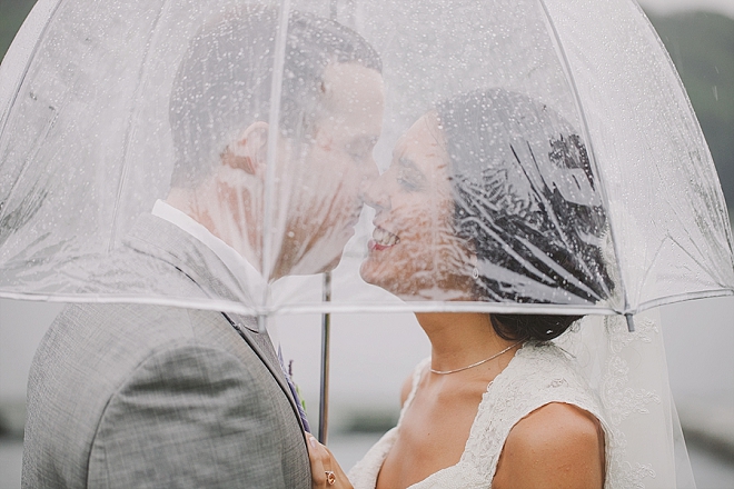 How stunning is this rainy lakeside umbrella photo?! We LOVE rainy weddings!