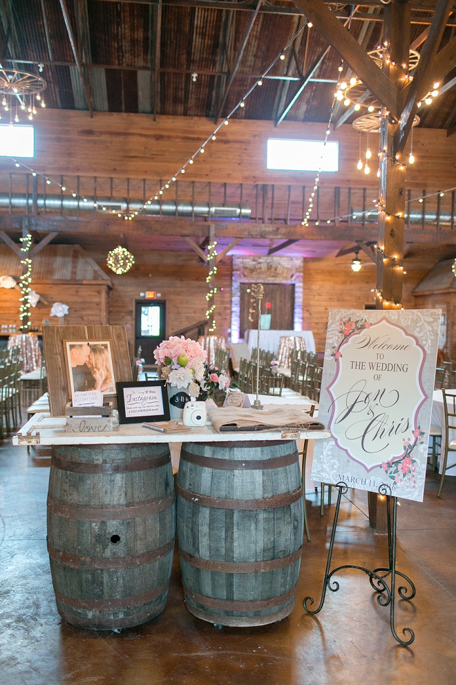 How darling is this couple's reception welcome table with whiskey barrels?!