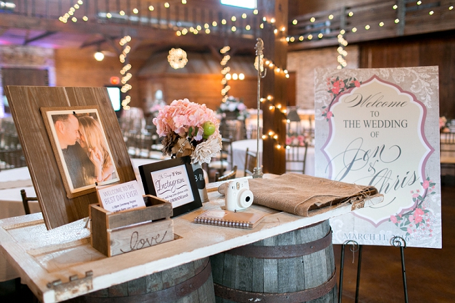 How darling is this couple's reception welcome table with whiskey barrels?!