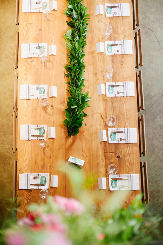 We're SWOONING over these farmhouse greenery covered reception tables!