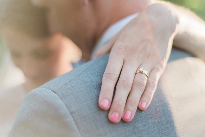 We love this super sweet shot of the brides pink wedding nails and ring!