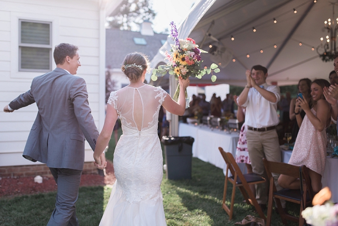 Entering their backyard reception as Mr. and Mrs!