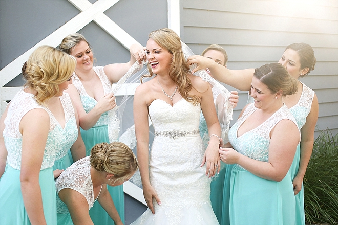 Sweet snap of the Bridesmaid's putting the finishing touches on the Bride!