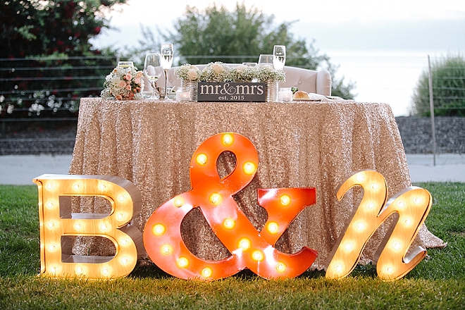 Check out this AMAZING sweetheart table with marquee lights!!
