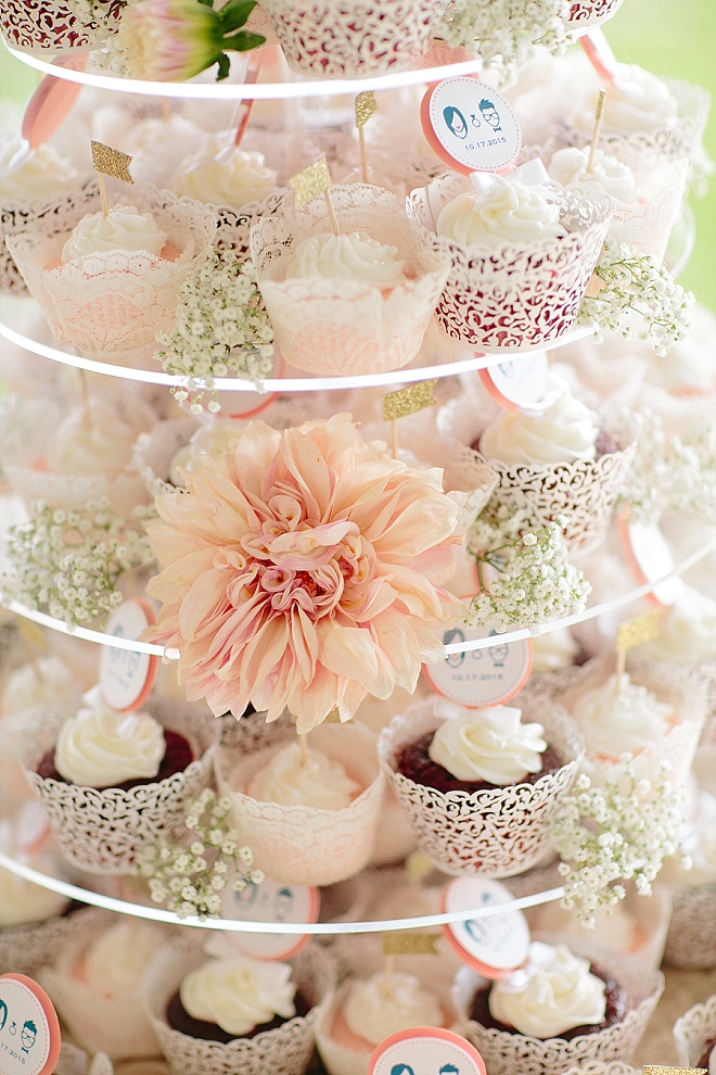 We love this stunning cut cake and customized cupcakes at this couple's gorgeous reception!