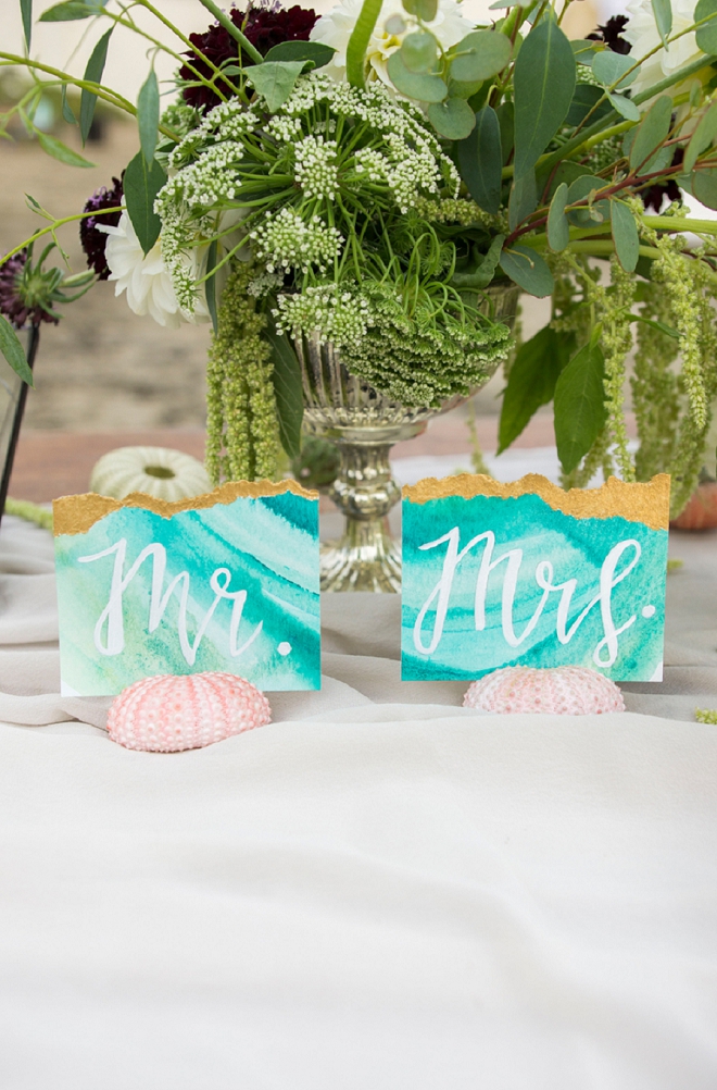 Loving these turquoise geode Mr. and Mrs. signs at this styled beach anniversary!