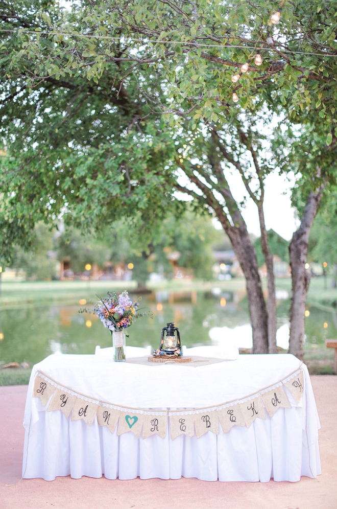 Loving this Mr. and Mrs. sweetheart table at their backyard wedding!
