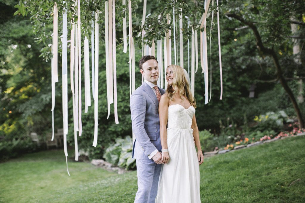 Easy Wedding DIY: Ribbons hanging from a tree as a photo backdrop.