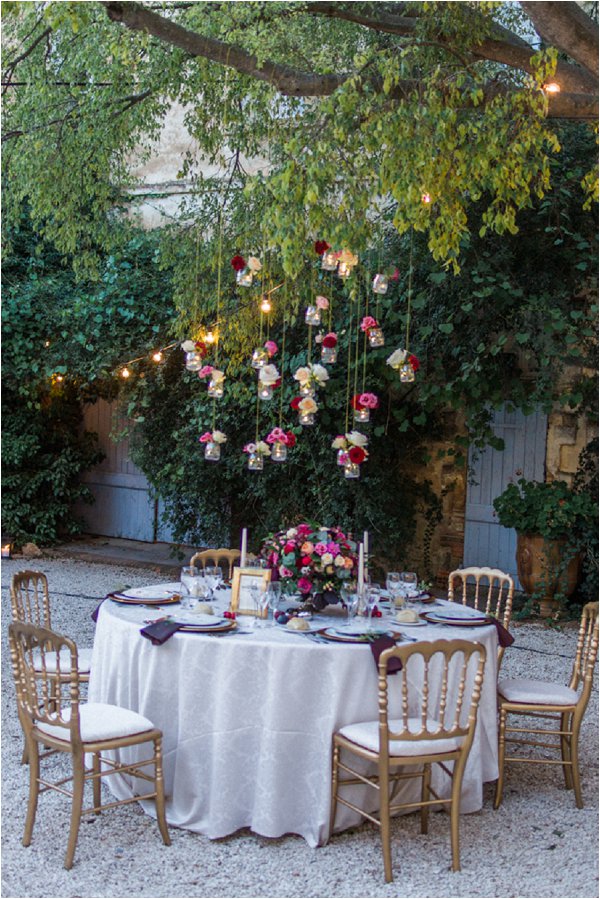 Hanging mason jars with flowers. Such an easy DIY for a spring/summer wedding.