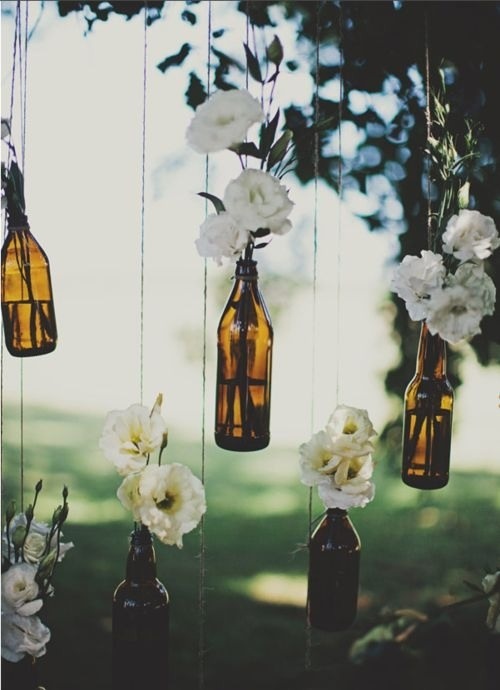 Wine bottles and flowers - awesome idea for an easy backyard wedding.