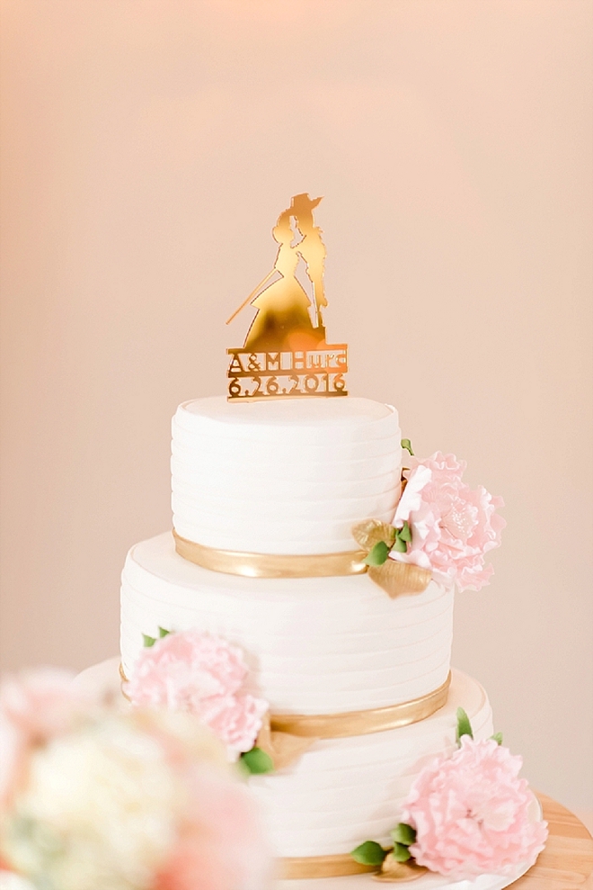 We love this stunning wedding cake with a cake topper of their engagement - so cute!
