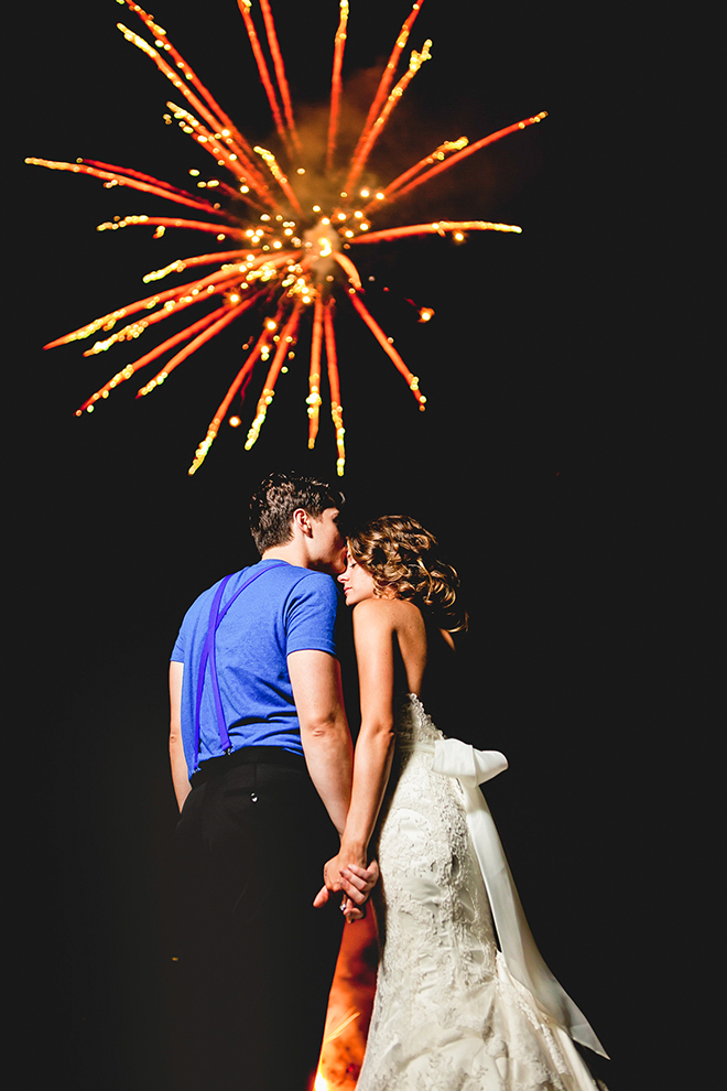 Gorgeous shot of a bride and groom during a firework show by George Street Photo & Video 