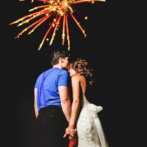 Gorgeous shot of a bride and groom during a firework show by George Street Photo & Video