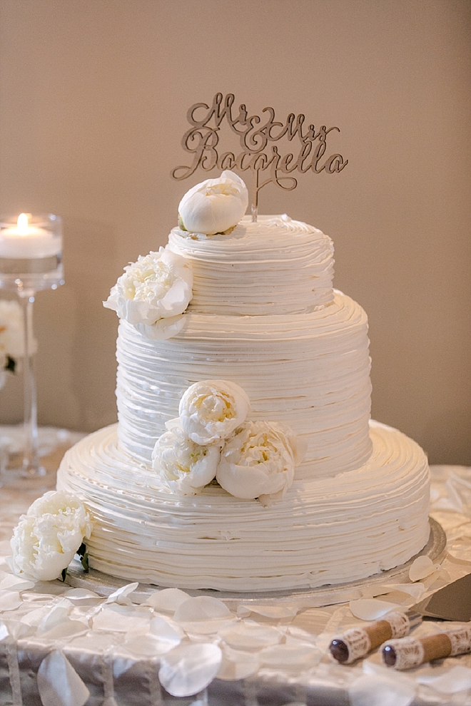 Gorgeous all white wedding cake with gold cake topper!
