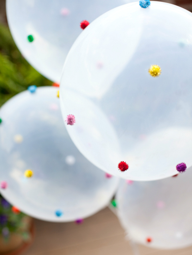 DIY Pom-pom balloons.  Such a fun idea for a wedding or birthday party!