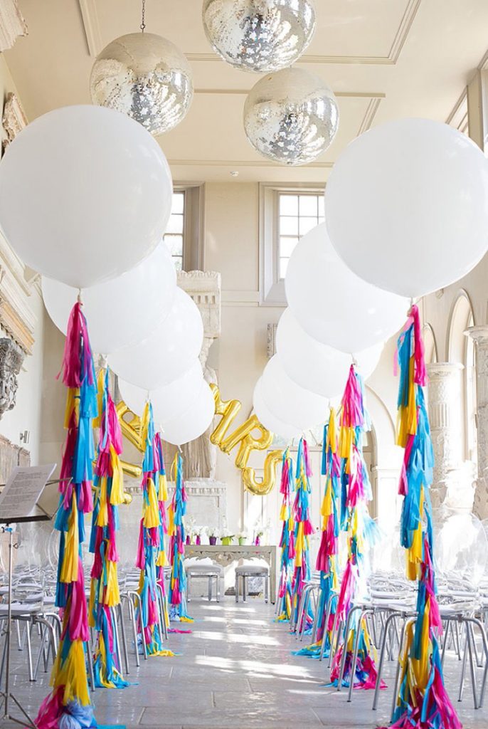 Bright and white wedding with oversized balloons, tassels, and glamour. Love!!