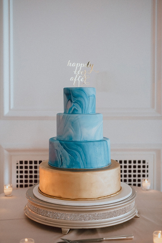 Swooning over this statement ombre blue wedding cake with gold cake topper!