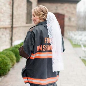 We're swooning over this super sweet snap of this Bride in her Hubby's fireman's jacket!