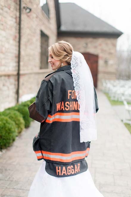We're swooning over this super sweet snap of this Bride in her Hubby's fireman's jacket!