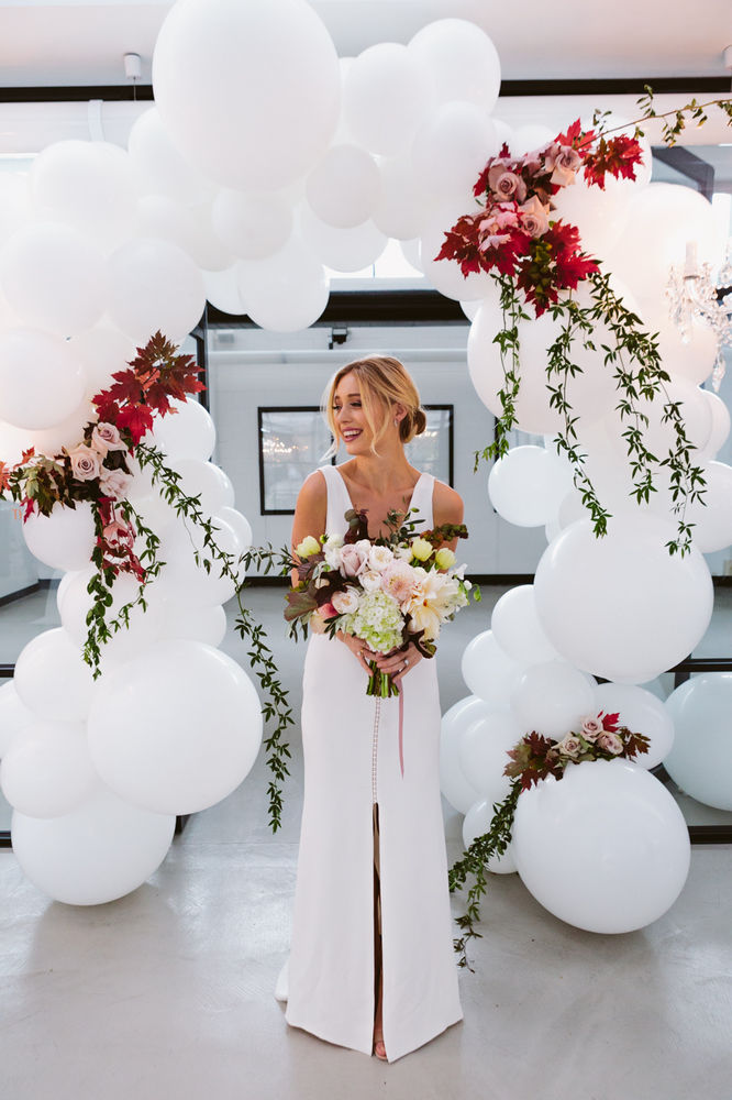 Gorgeous balloon arch.  White balloons with real flowers! So beautiful for a wedding.