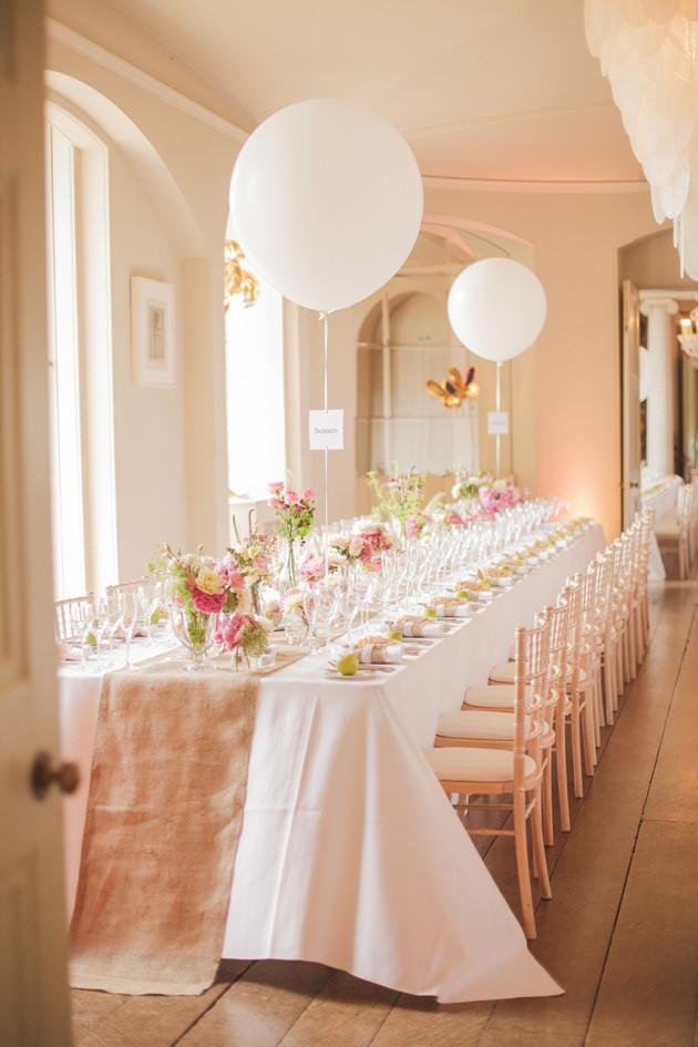 So elegant. Pink wedding with white balloons as table numbers. 