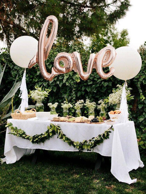 Love letter balloons.  Such a cute way to spice up a food or dessert table at a wedding.