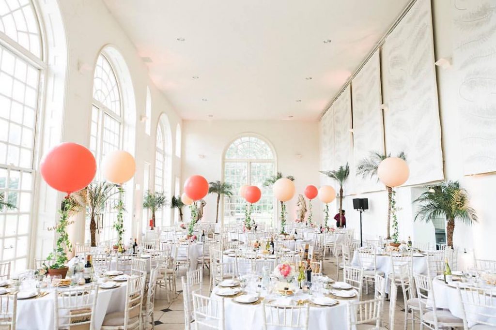 Tropical palm tree wedding! Love the balloons used as table numbers and the coral.