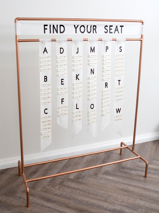 This DIY copper pipe seating card display is seriously awesome!