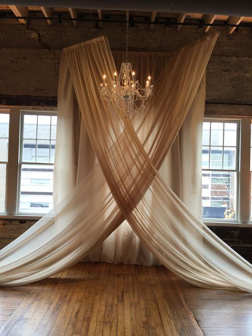 Chic and classy wedding fabric draping with a chandelier. 