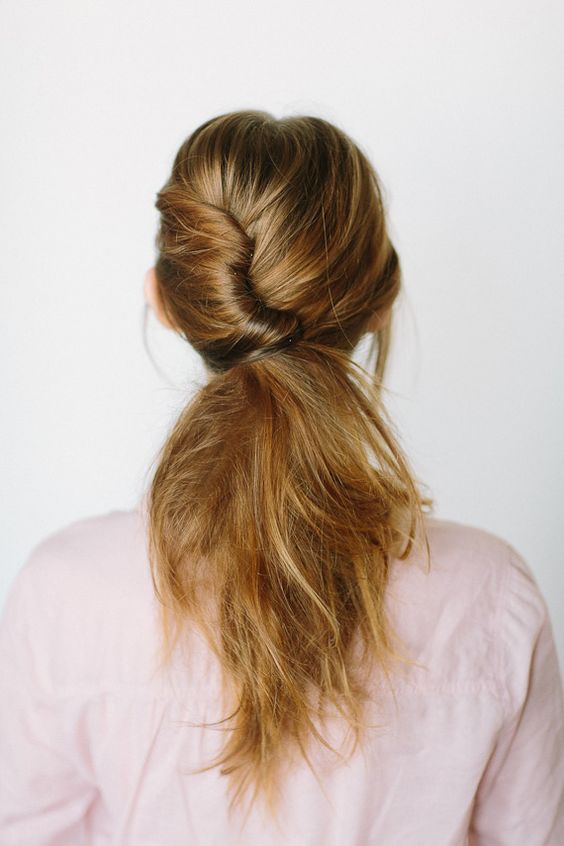 Try a twisted ponytail for your winter wedding.