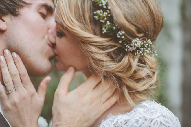 Loose updo with baby's breath for a winter wedding.