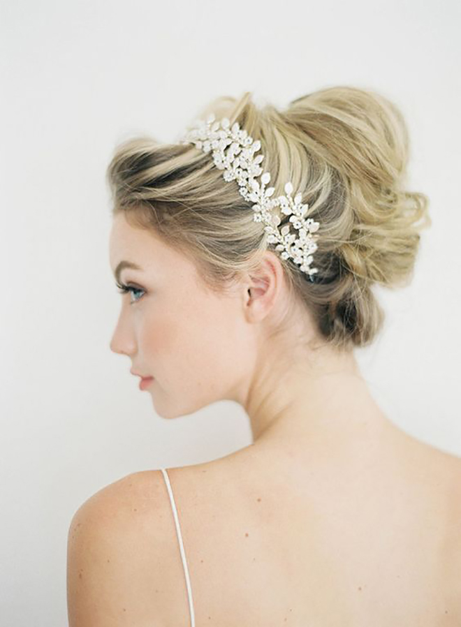 A high messy bun is a great idea for winter wedding hair.