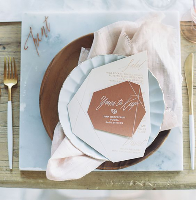 We are OBSESSED with this marble and copper places setting.